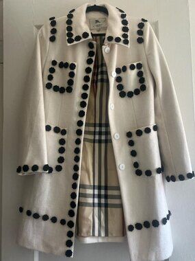 Burberry cream coat with black pom poms